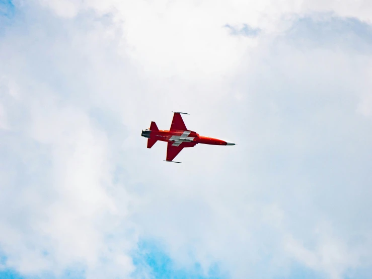 an airplane flying in the sky with clouds