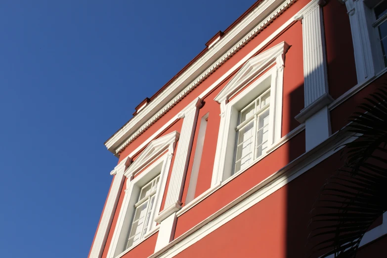 red building with white trim and white windows on a clear day