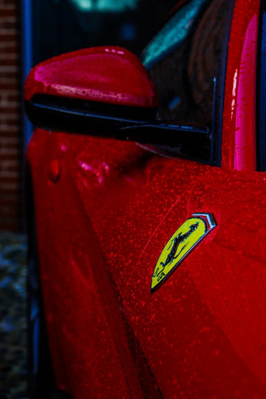 a close up of the side window and bumper sticker of a red car