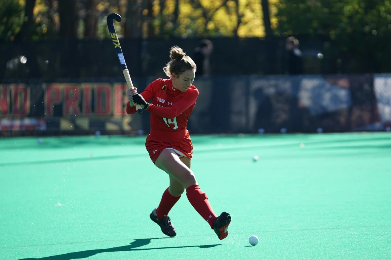 a girl on field hockey playing during a game