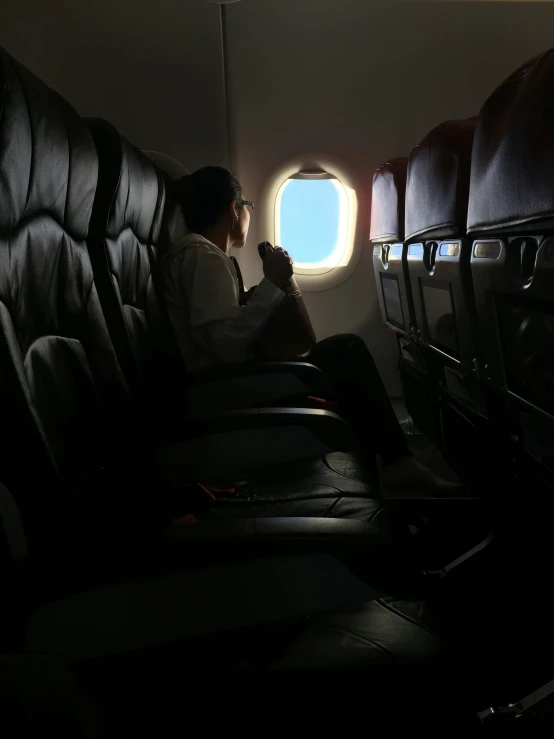 the man is sitting alone in his seat with his cat