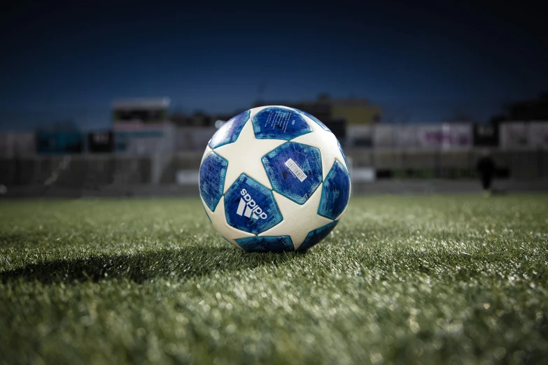 a white and blue soccer ball is on the ground