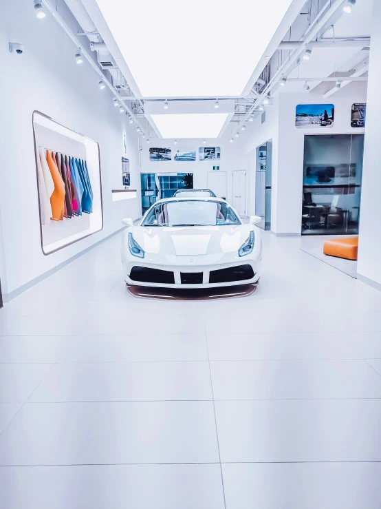 a white car is sitting in the middle of a white room