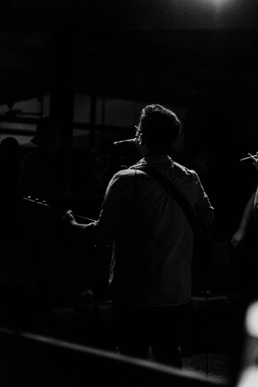 black and white po of people in dark room