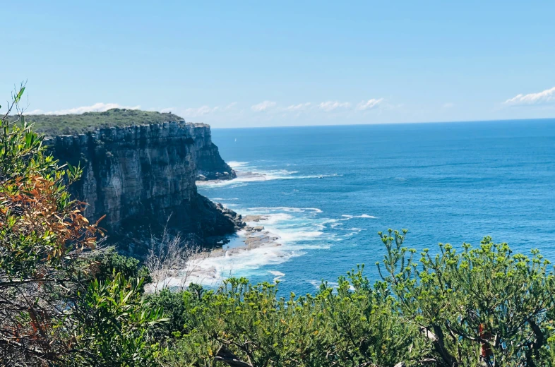 the cliff is high on the water and blue