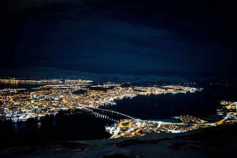 a view of the city lights at night from top of a mountain