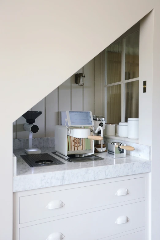 this kitchen has a white counter and countertop