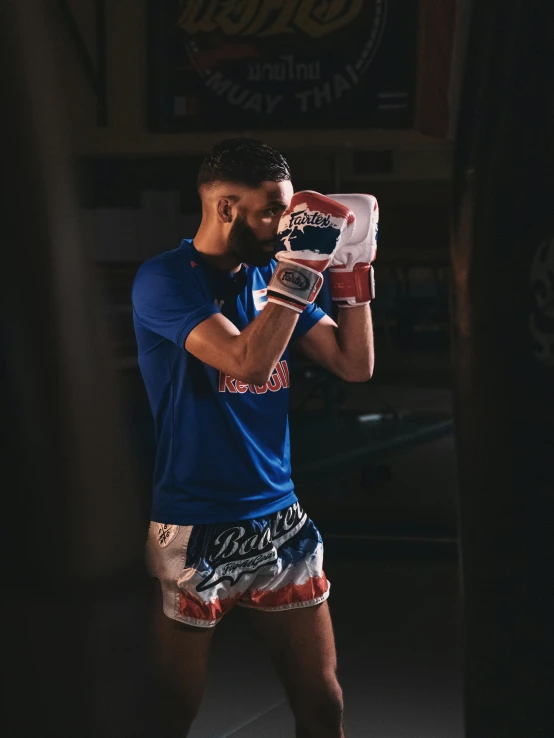 a man in a gym doing a kickbox position