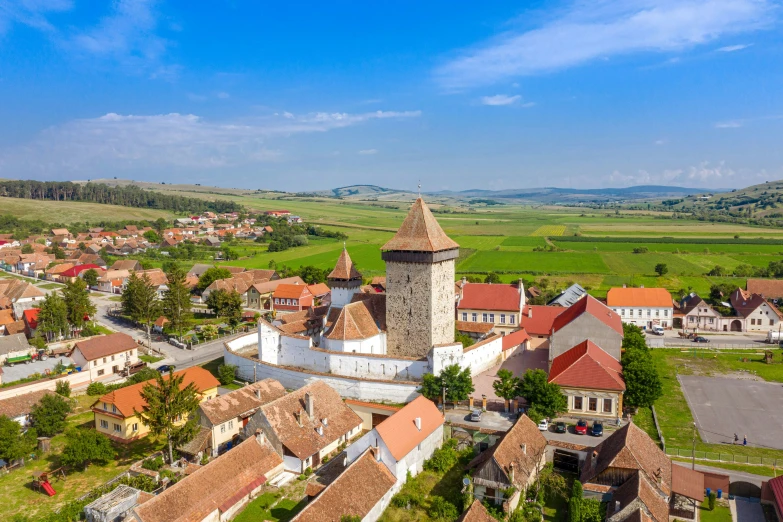 a small village is surrounded by lush green fields