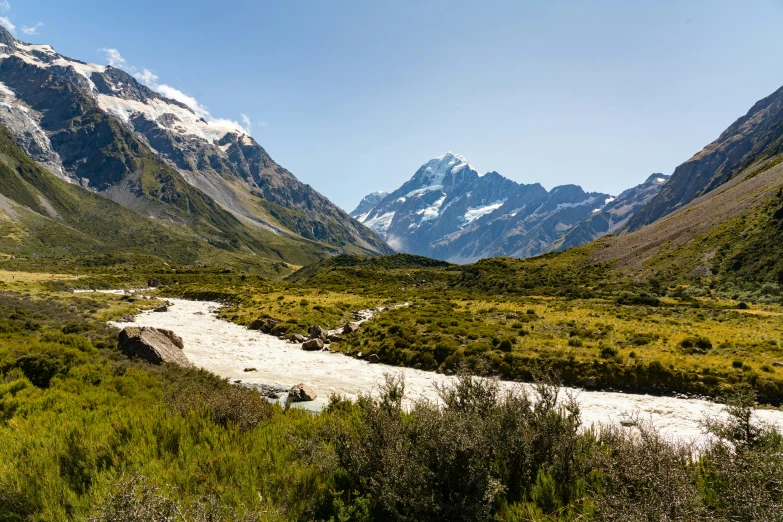 the mountains around the valley can be seen with a river flowing between them