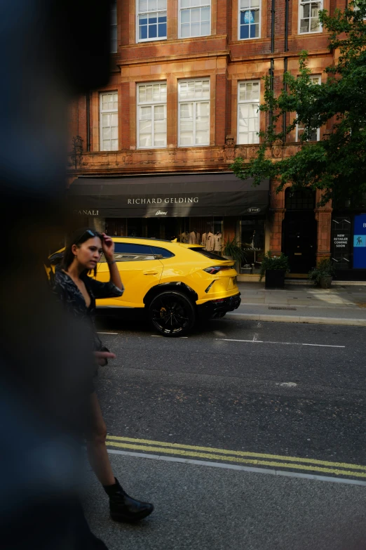 a woman on the side of the street talking on her cell phone