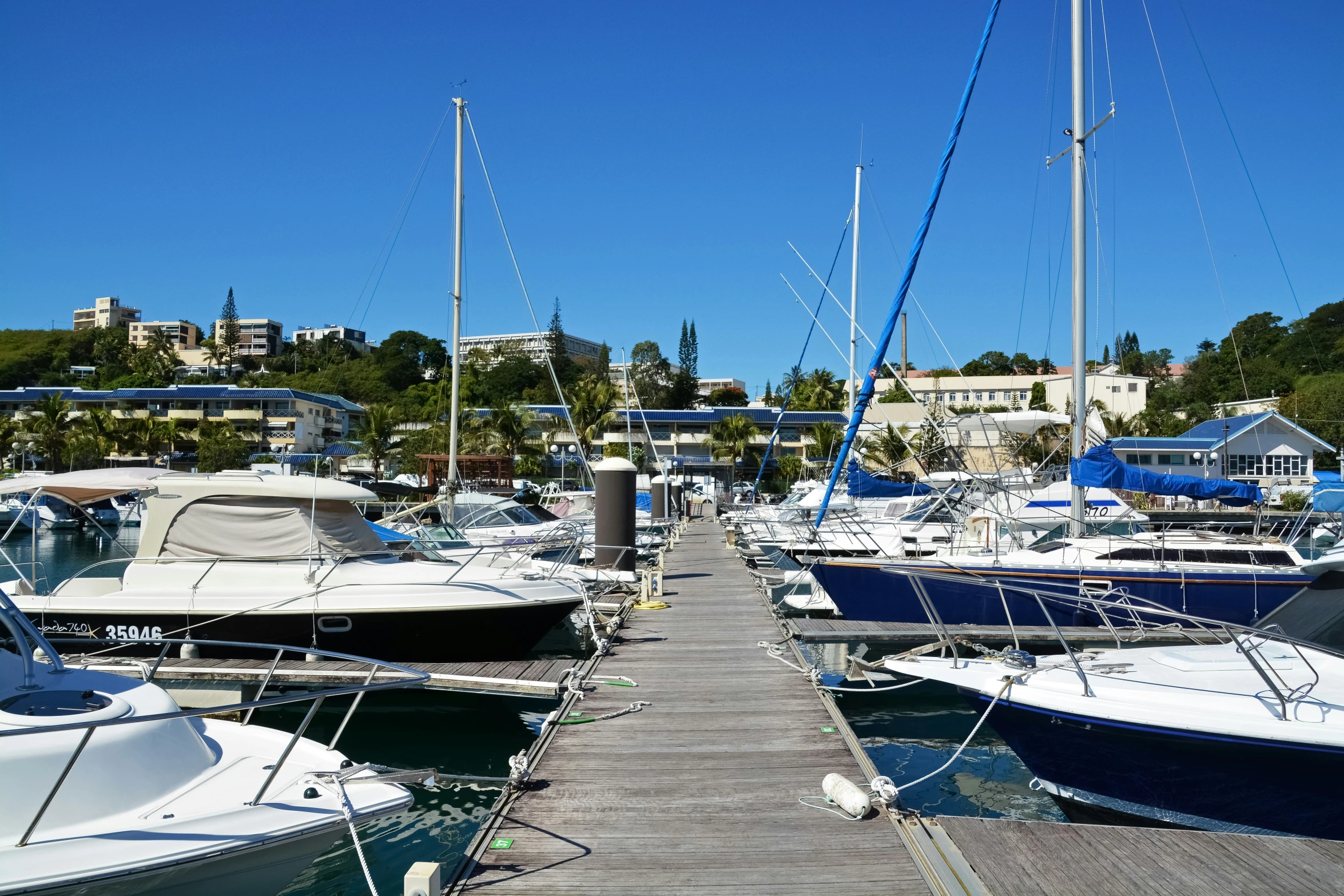 several boats parked at the dock in a marina