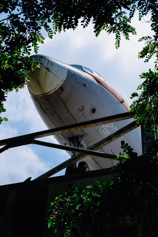 a jet sitting on top of a cement structure under a blue sky