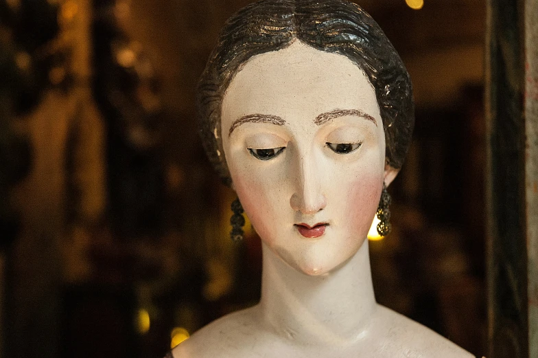 a statue of a woman is in front of a display case