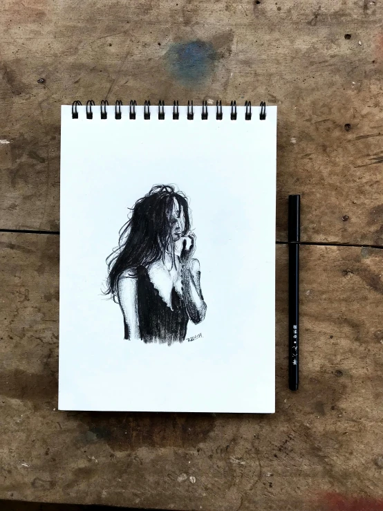 a drawing of a woman is on a piece of paper