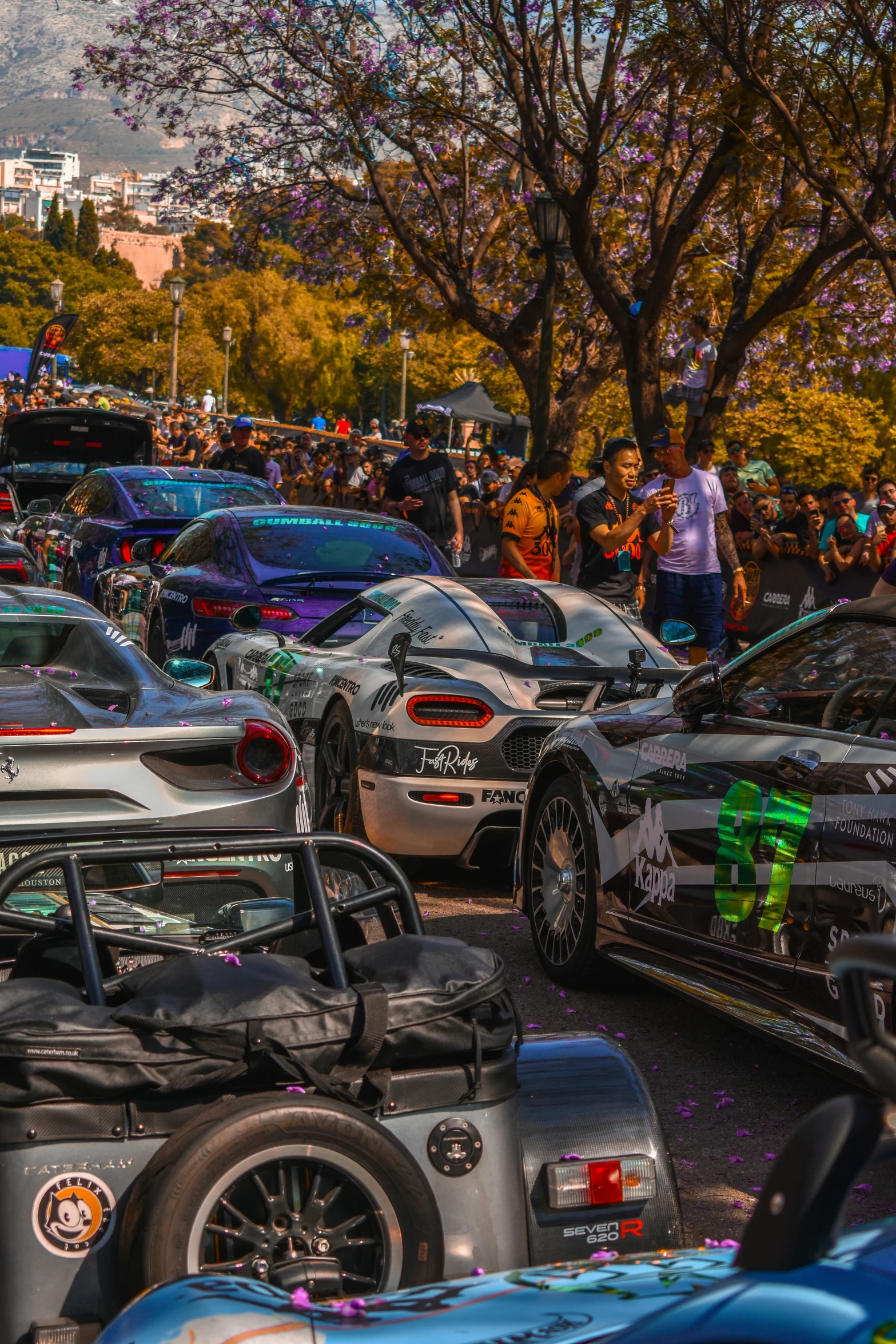 a crowd of people standing next to a parking lot