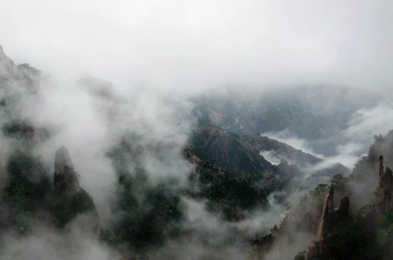 the top of a mountain covered in clouds