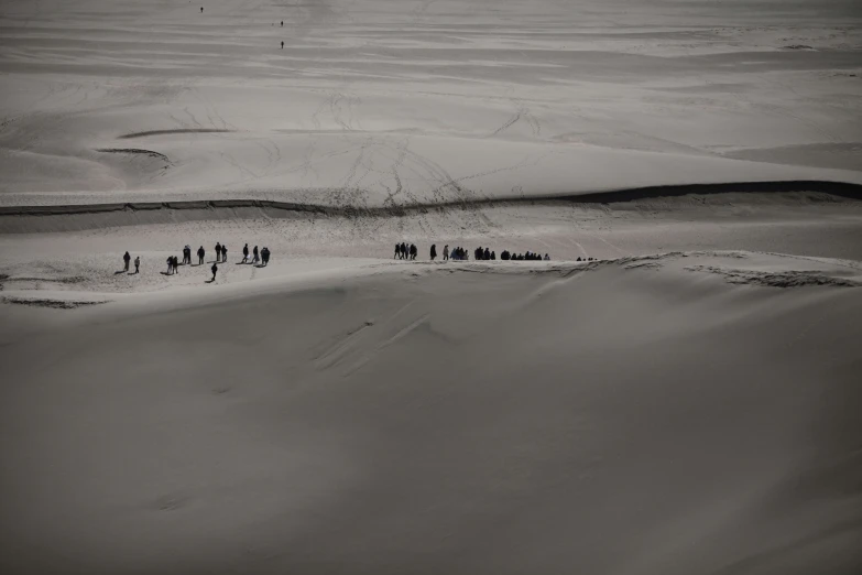 an aerial view of a group of people in the desert