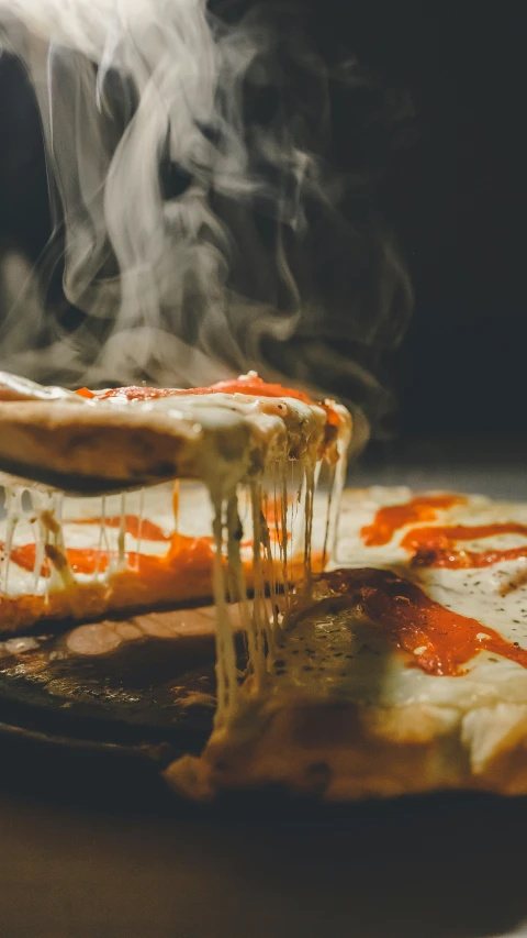 a few pieces of pizza on a  board covered with sauce