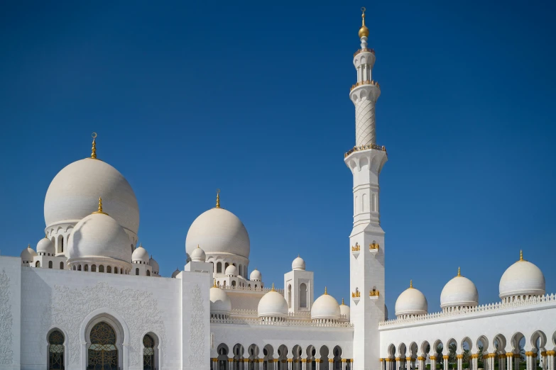 an ornate building with multiple white domes and pillars