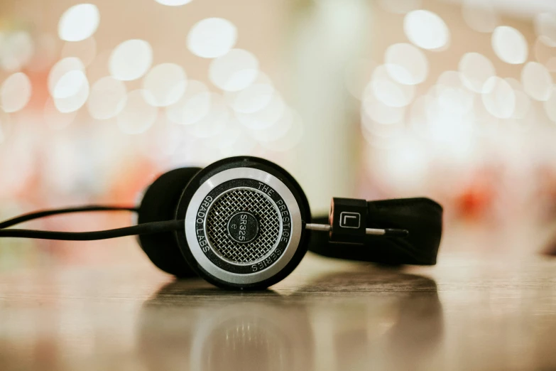 headphones are sitting on the surface with one ear cord in front of the other