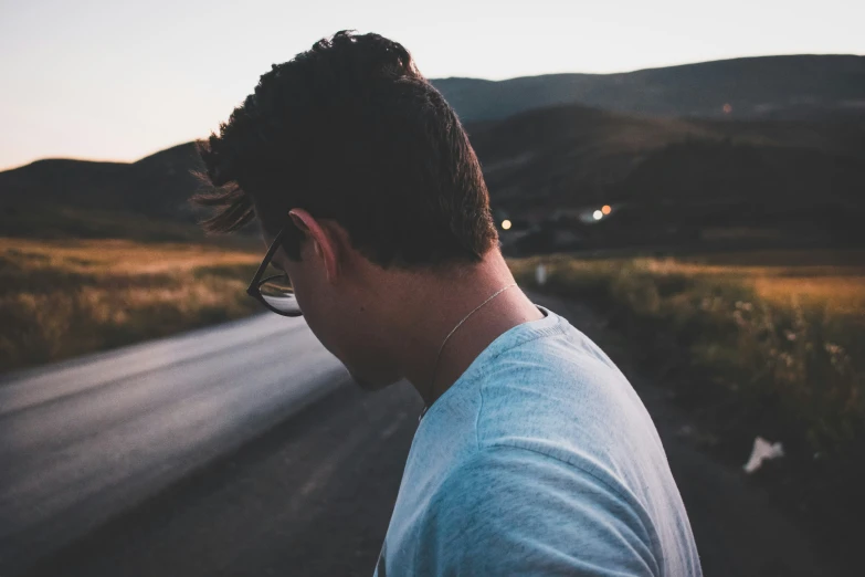 a man is in the middle of a road and staring ahead