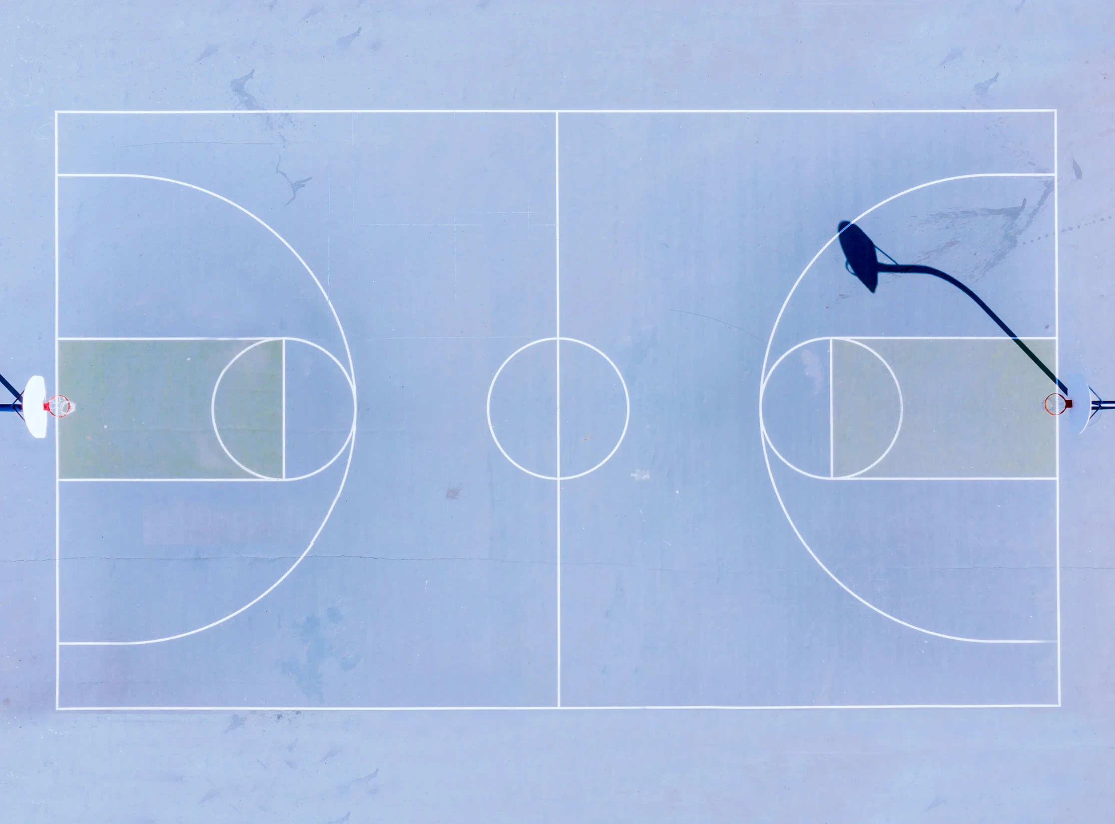 top view of two blue and white basketball courts