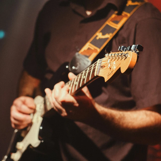 the musician is playing a guitar on stage