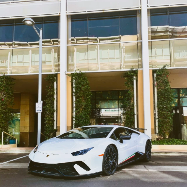 a white car parked in front of a building