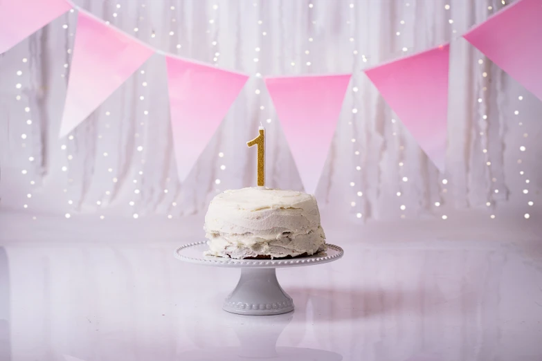 birthday cake on the table in front of a banner and party decoration