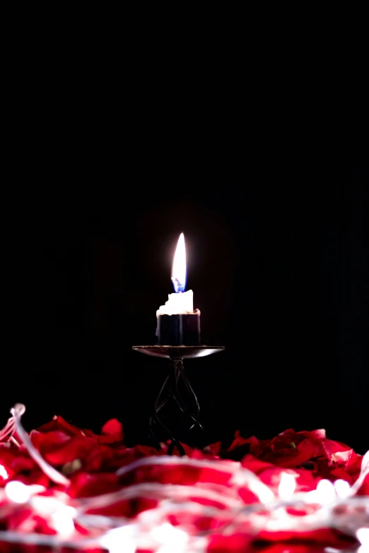 a lit candle with light shining on top