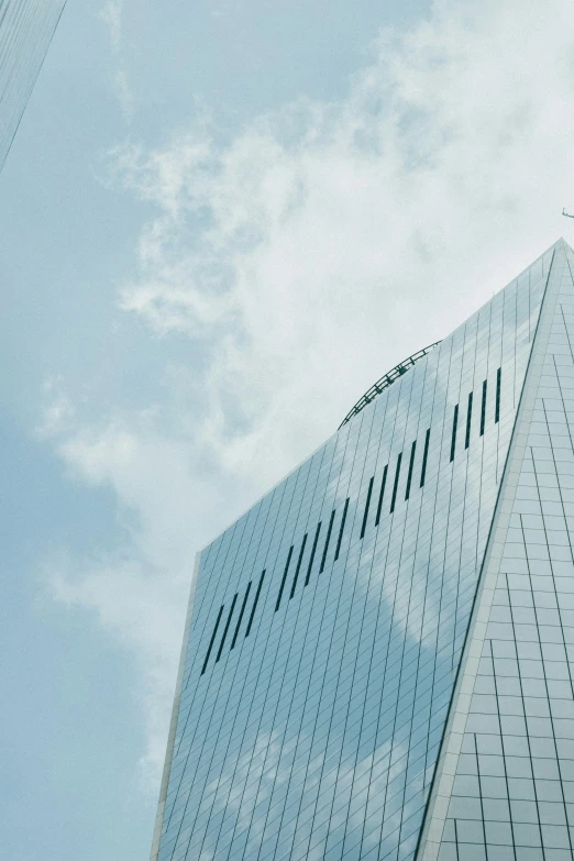 an upward view of a large building against a blue sky