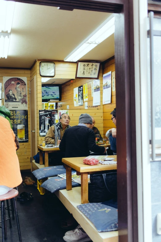 a group of people are gathered at tables