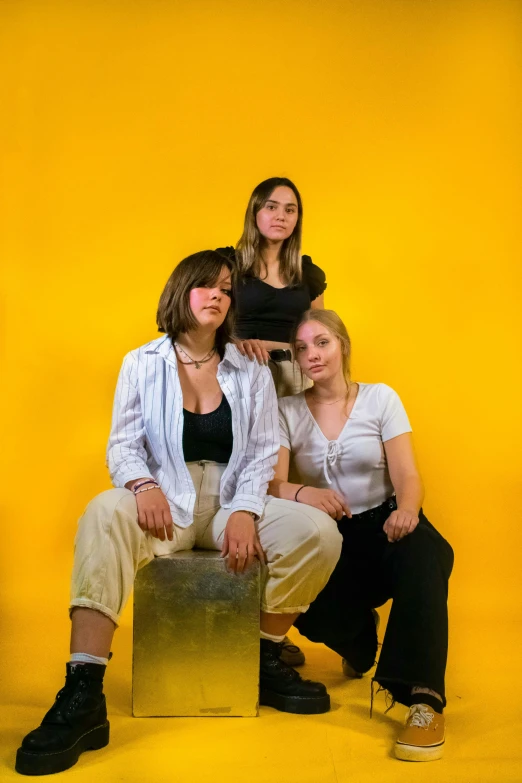 four women in white and black clothes posing