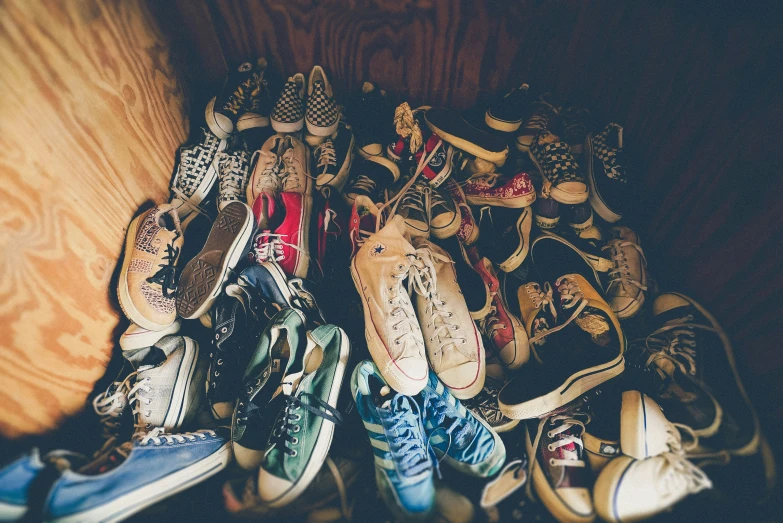 many pairs of shoes sitting on top of each other