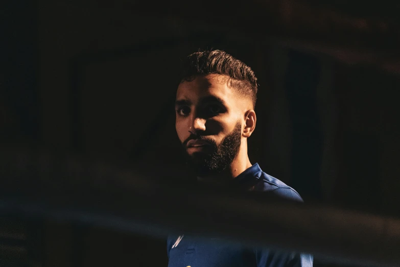 a man with a beard in a dark room