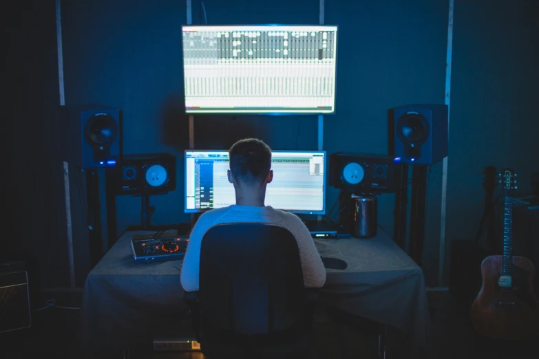 a person sitting in front of a computer monitor