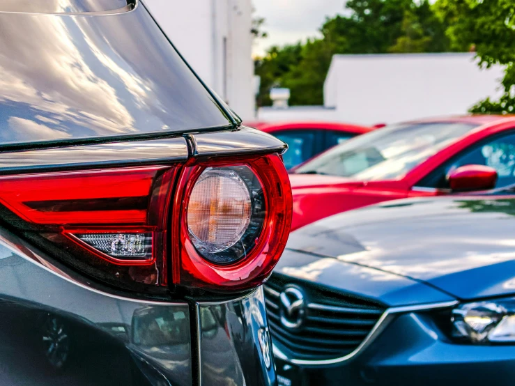 the front end of a car that is parked next to other cars