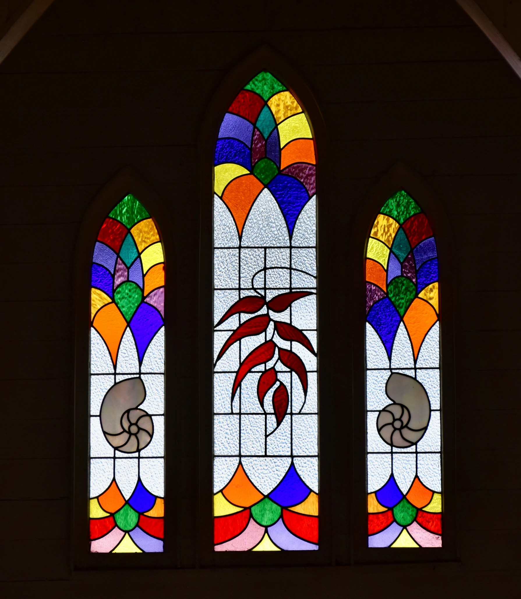 the stained glass windows inside the church have a crab symbol