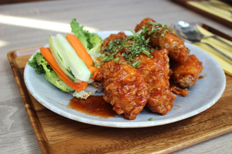 food item displayed on plate with utensils on wooden tray