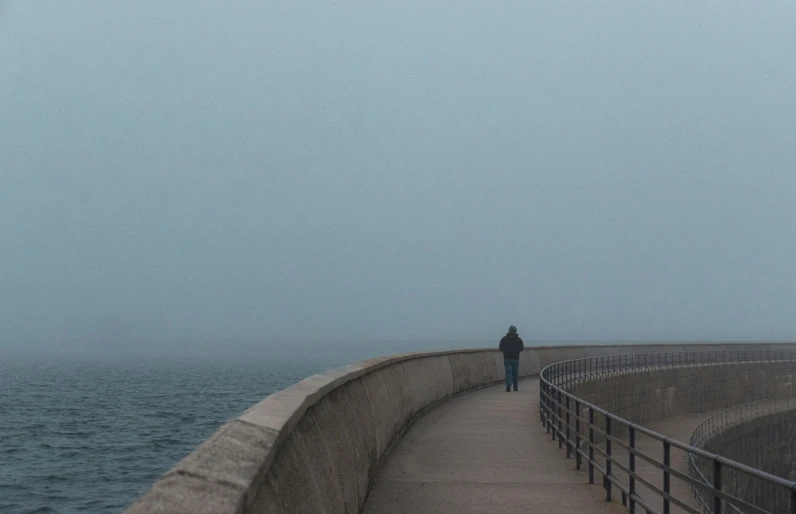 an image of a man standing on the side of the sea