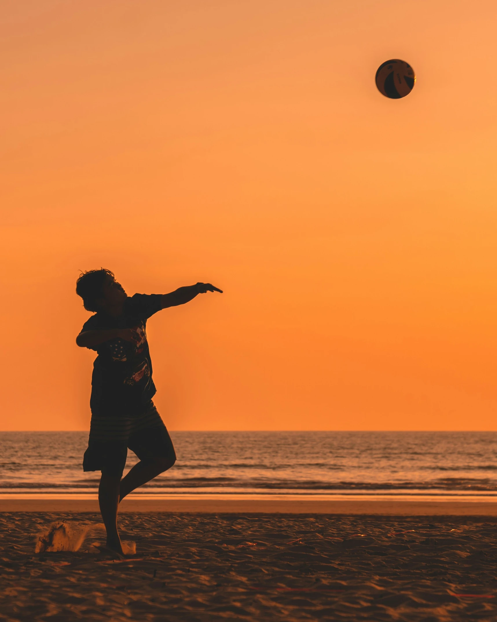 a man standing on the beach near the ocean