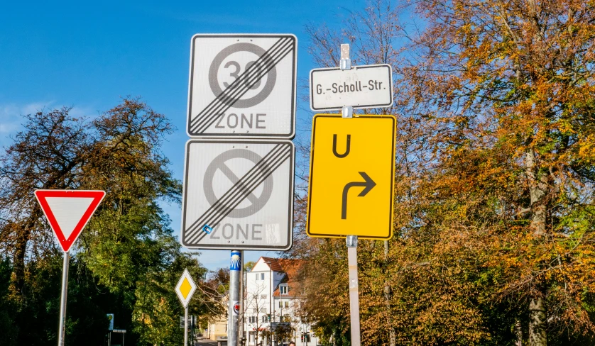 street signs on poles are indicating direction of people crossing