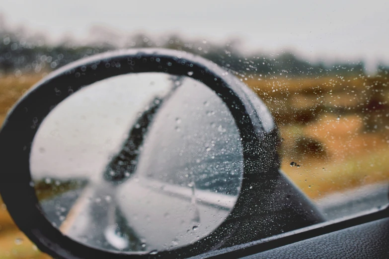 the reflection in a mirror of a car and the back of it