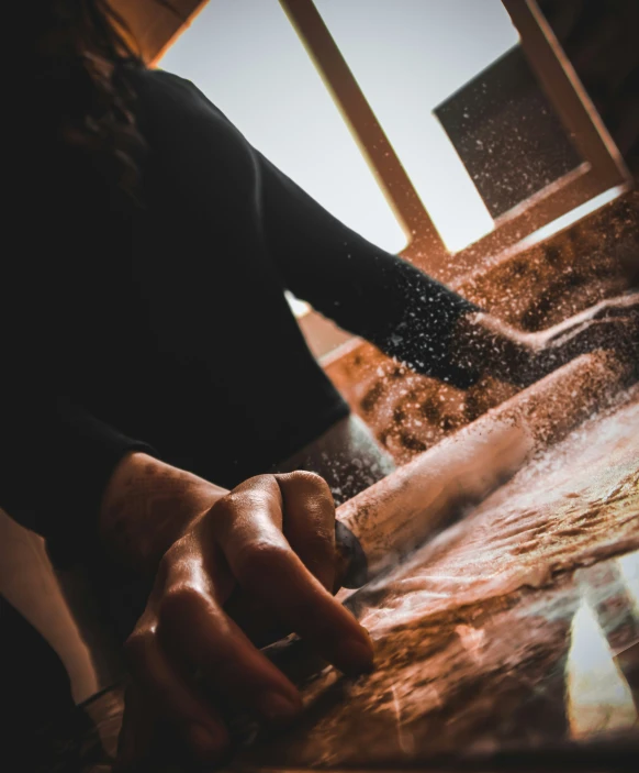 a person is chopping wood on a  board