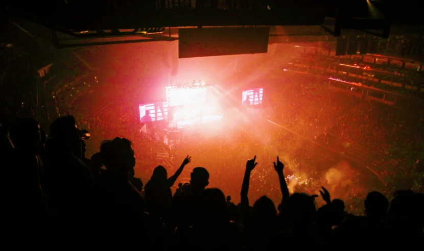 a concert scene with many people standing around