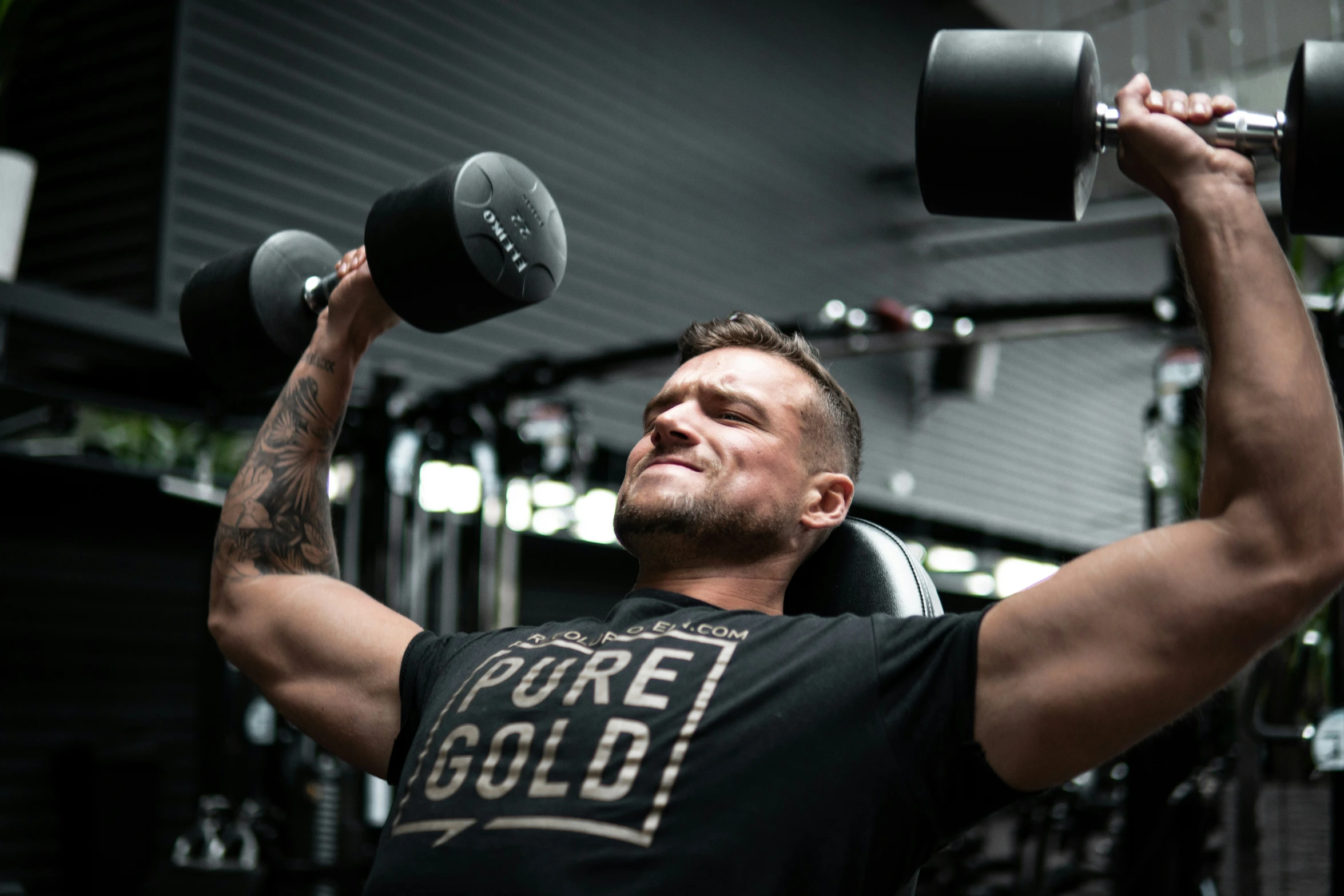 a man lifting some weights in his arms