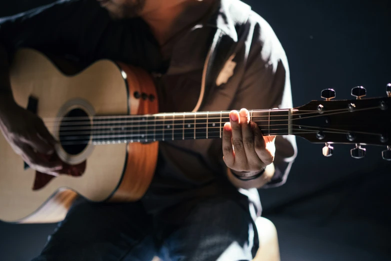 a man is playing the guitar on stage