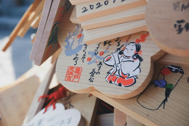 an assortment of chopsticks on display in oriental writing