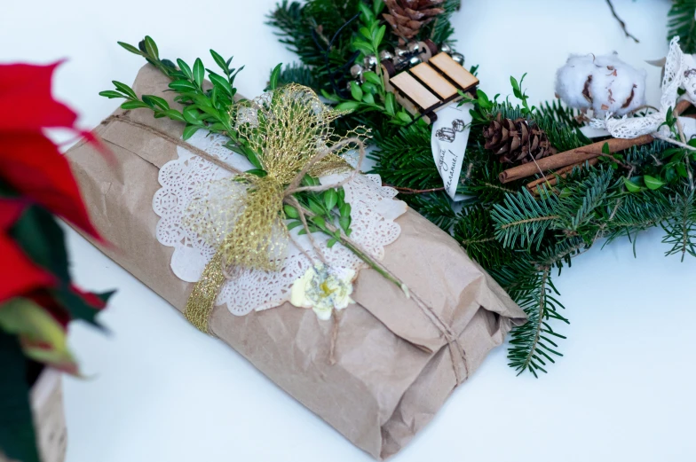 a paper bag tied with twine and a white flower